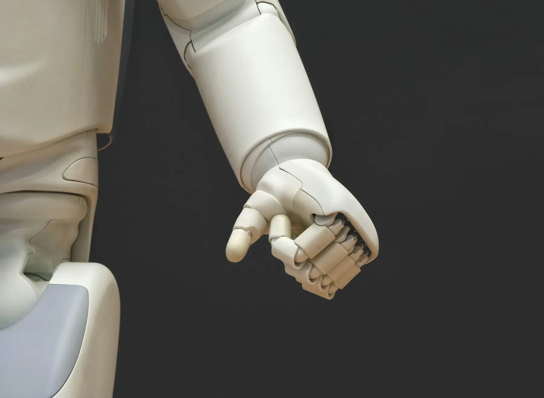 Close-up of a white robotic hand with articulated fingers